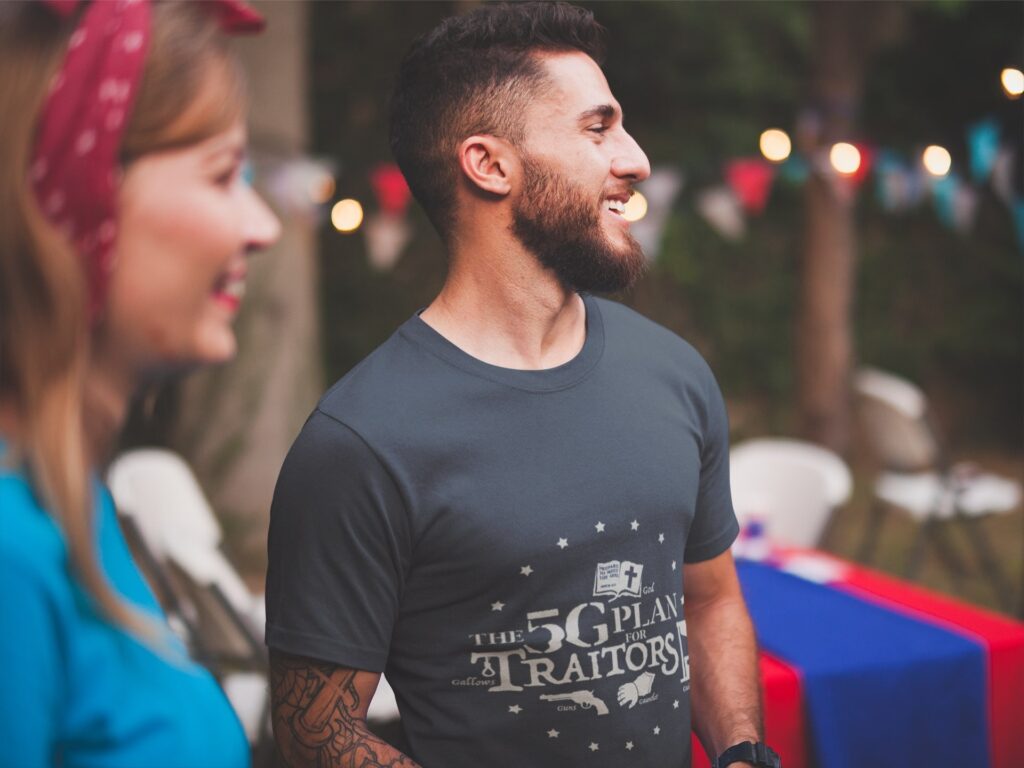 Man wearing The 5G Plan for Traitors t-shirt at a 4th of July party